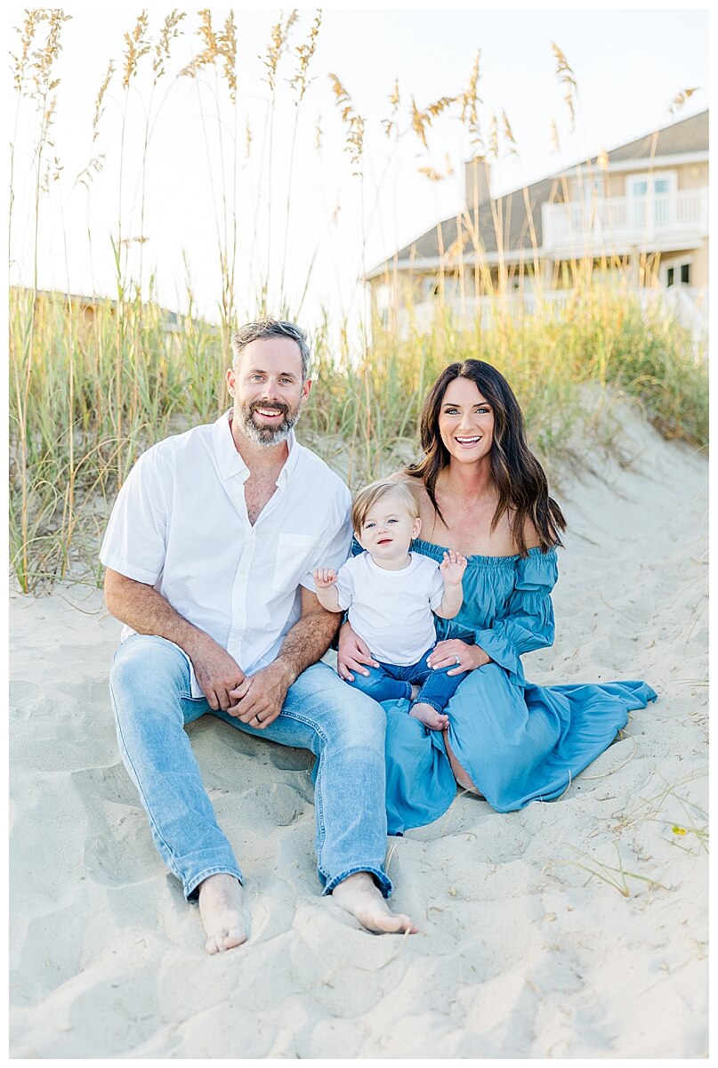 family photo on sand in emerald isle with one year old baby boy